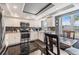 Bright kitchen featuring stainless steel appliances, white cabinetry, and a cozy breakfast nook at 7 Elgin Pl # 202, Dunedin, FL 34698
