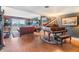 Spacious living room featuring a grand piano, comfortable seating, and access to the balcony at 7 Elgin Pl # 202, Dunedin, FL 34698