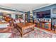 Open living area with leather seating, piano, and a large TV on a console with storage at 7 Elgin Pl # 202, Dunedin, FL 34698