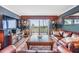 Relaxing living room with plush furniture, entertainment center, and sliding doors that offer scenic views at 7 Elgin Pl # 202, Dunedin, FL 34698