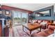 Comfortable living room with balcony access, a leather sofa, and a stylish coffee table on an area rug at 7 Elgin Pl # 202, Dunedin, FL 34698
