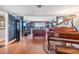 Elegant living room with wood floors, a grand piano, comfortable seating, and a large window at 7 Elgin Pl # 202, Dunedin, FL 34698