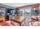 Relaxing living room with a balcony view, a leather couch, and an entertainment center at 7 Elgin Pl # 202, Dunedin, FL 34698