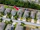 Aerial view of a neighborhood showcasing well-manicured lawns and a home with a neatly maintained roof at 7034 Emerald Spring Loop, New Port Richey, FL 34653