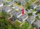 Neighborhood aerial view, highlighting a home's backyard, play area, and proximity to other residences at 7034 Emerald Spring Loop, New Port Richey, FL 34653