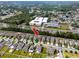 Aerial view featuring the location of a home near a highway and commercial buildings in the distance at 7034 Emerald Spring Loop, New Port Richey, FL 34653