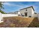 Large backyard with a white fence, concrete patio, and space for outdoor activities at 7034 Emerald Spring Loop, New Port Richey, FL 34653
