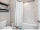 Clean, white bathroom with a shower and tub combination and functional storage at 7034 Emerald Spring Loop, New Port Richey, FL 34653