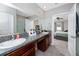 Bathroom featuring double sinks, a granite countertop, and a view into the bedroom at 7034 Emerald Spring Loop, New Port Richey, FL 34653