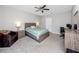 Cozy bedroom featuring neutral walls, ceiling fan, and comfortable carpeting at 7034 Emerald Spring Loop, New Port Richey, FL 34653