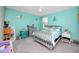 Brightly colored bedroom with a crib and natural light streaming through the window at 7034 Emerald Spring Loop, New Port Richey, FL 34653
