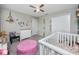 Spacious Bedroom with a crib, changing table, and playful animal decals on the wall at 7034 Emerald Spring Loop, New Port Richey, FL 34653