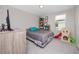 Functional bedroom offers comfortable sleeping and a play area by the window at 7034 Emerald Spring Loop, New Port Richey, FL 34653