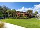 Clubhouse showcasing manicured lawns, lush tropical landscaping, and welcoming entrance perfect for social gatherings at 7034 Emerald Spring Loop, New Port Richey, FL 34653