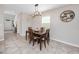 Cozy dining area featuring a dark wood table, pendant lighting, and tile flooring at 7034 Emerald Spring Loop, New Port Richey, FL 34653