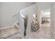 Inviting entryway with neutral tones, tiled floor, and staircase leading to the upper level at 7034 Emerald Spring Loop, New Port Richey, FL 34653