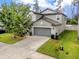 Charming two-story home with a well-maintained lawn, two car garage and inviting curb appeal at 7034 Emerald Spring Loop, New Port Richey, FL 34653