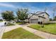 Suburban home exhibiting well-maintained landscaping, spacious driveway, and a neutral exterior paint scheme at 7034 Emerald Spring Loop, New Port Richey, FL 34653