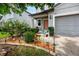 Charming home entrance featuring a garden, solar lights, and an inviting front door at 7034 Emerald Spring Loop, New Port Richey, FL 34653