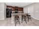 Charming kitchen featuring a breakfast bar, stainless appliances, and ample cabinet space at 7034 Emerald Spring Loop, New Port Richey, FL 34653