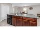 Kitchen island boasts dark wood cabinets and a double sink with granite countertop at 7034 Emerald Spring Loop, New Port Richey, FL 34653