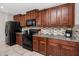 Updated kitchen with granite countertops, mosaic backsplash, and black appliances at 7034 Emerald Spring Loop, New Port Richey, FL 34653