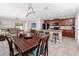 Spacious open concept kitchen and dining area with stainless steel appliances, bar seating, and plenty of counter space at 7034 Emerald Spring Loop, New Port Richey, FL 34653
