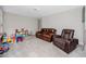 Spacious living area with comfortable seating and play area, perfect for relaxation at 7034 Emerald Spring Loop, New Port Richey, FL 34653