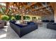 Outdoor lounge area featuring comfortable seating, picnic tables, and beautiful stone accents with open beam framing at 7034 Emerald Spring Loop, New Port Richey, FL 34653
