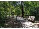 Scenic walking path lined with benches winding through a lush, shaded wooded area at 7034 Emerald Spring Loop, New Port Richey, FL 34653