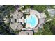 Beautiful aerial view of community pool area with lounge chairs, lush landscaping, and inviting recreational space at 731 Cruise View Dr, Tampa, FL 33602