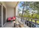 Cozy balcony with outdoor seating and a view of the lush surroundings and nearby palm trees at 731 Cruise View Dr, Tampa, FL 33602