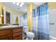 Bright bathroom featuring a sink, toilet, and bathtub with a blue and gray shower curtain at 731 Cruise View Dr, Tampa, FL 33602