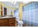 Practical bathroom featuring a vanity sink, toilet, and a shower with a colorful curtain providing a functional and refreshing space at 731 Cruise View Dr, Tampa, FL 33602