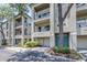 Three-story condo building featuring balconies, attached garages, and mature trees offering shade at 731 Cruise View Dr, Tampa, FL 33602