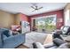 Bright living room with sliding glass doors to balcony, ceiling fan, and views of adjacent kitchen at 731 Cruise View Dr, Tampa, FL 33602