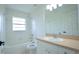 Bright bathroom with a shower-tub combination, a toilet, and a single vanity at 7551 52Nd N St, Pinellas Park, FL 33781