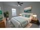 Bedroom with a large bed, nightstands, and a large window with natural light at 7551 52Nd N St, Pinellas Park, FL 33781