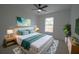 Bedroom with a large bed, nightstands, and a large window with natural light at 7551 52Nd N St, Pinellas Park, FL 33781