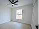 Bright bedroom with a ceiling fan and a large window bringing in natural light at 7551 52Nd N St, Pinellas Park, FL 33781