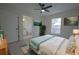 Bright bedroom featuring a ceiling fan, stylish decor, and ensuite bathroom access at 7551 52Nd N St, Pinellas Park, FL 33781