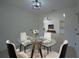 Bright dining room features modern light fixture, round glass table, and four chairs at 7551 52Nd N St, Pinellas Park, FL 33781
