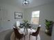 Cozy dining area with a modern glass table, decorative chandelier, and a large window at 7551 52Nd N St, Pinellas Park, FL 33781