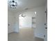 Open-concept living space with archway, fan, light wood floors and modern finishes at 7551 52Nd N St, Pinellas Park, FL 33781