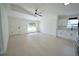 Bright living room with a fan, large window, light wood floors, and mini bar at 7551 52Nd N St, Pinellas Park, FL 33781