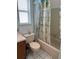 Bathroom with a shower and a whimsical beach-themed shower curtain at 7616 Colonial Ct, Tampa, FL 33615