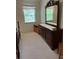 Spacious bedroom with carpet flooring, a window, and a large dresser with mirror at 7616 Colonial Ct, Tampa, FL 33615