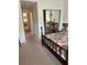 Bedroom showing a wooden bed frame with view of closet and hallway at 7616 Colonial Ct, Tampa, FL 33615