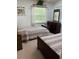 Bedroom featuring two beds, a dresser with a mirror, and a window at 7616 Colonial Ct, Tampa, FL 33615