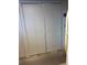 Storage closet featuring bifold doors and additional storage on top shelf at 7616 Colonial Ct, Tampa, FL 33615